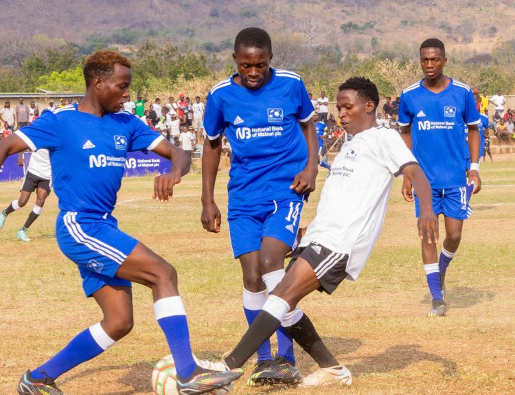 Mkombezi Tough Challengers in white battles for possession against Young Challengers Reserve 002