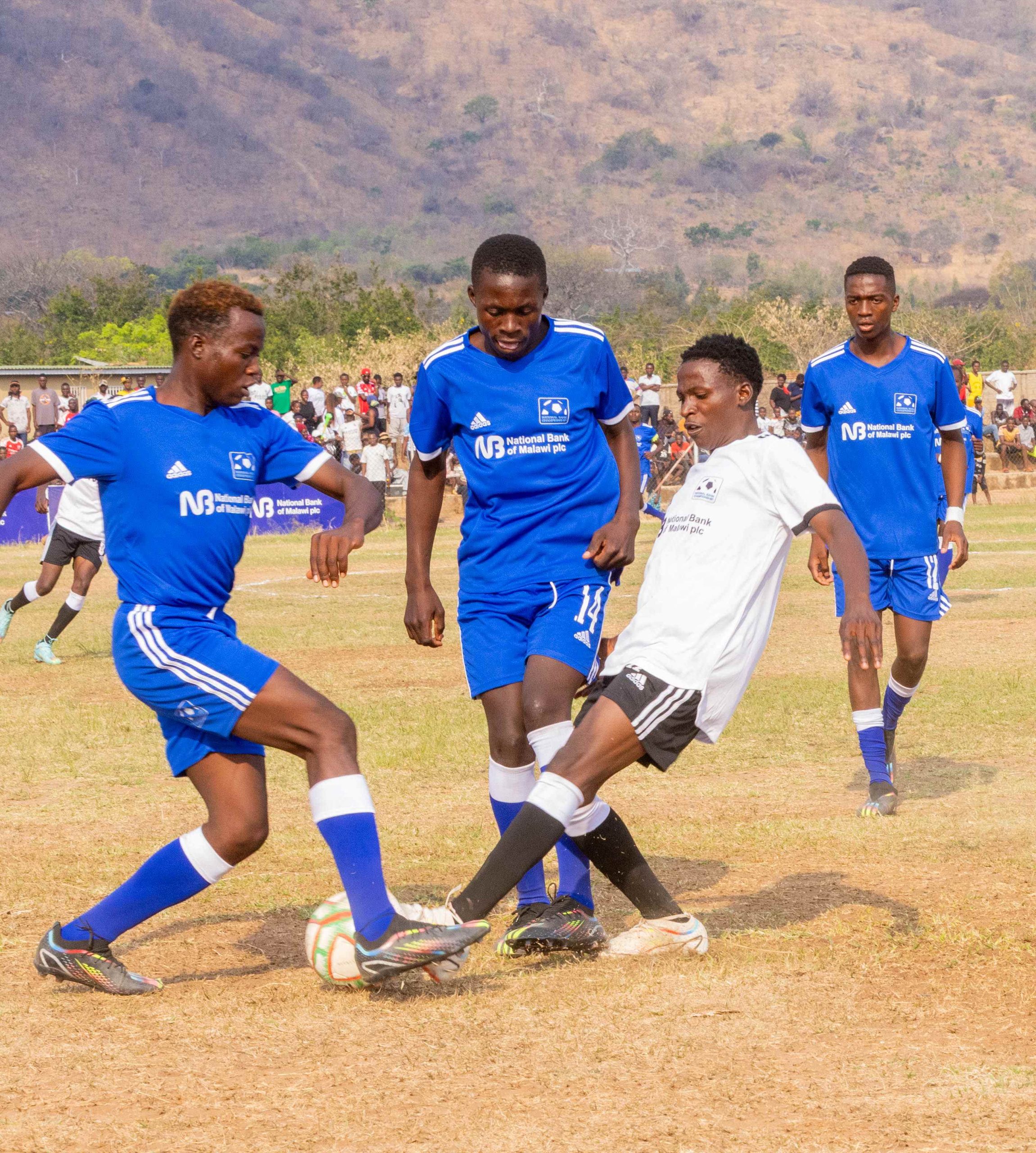 Mkombezi Tough Challengers in white battles for possession against Young Challengers Reserve 002 scaled